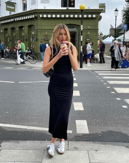 a woman wearing black maxi tank dress and white Adidas Samba sneakers