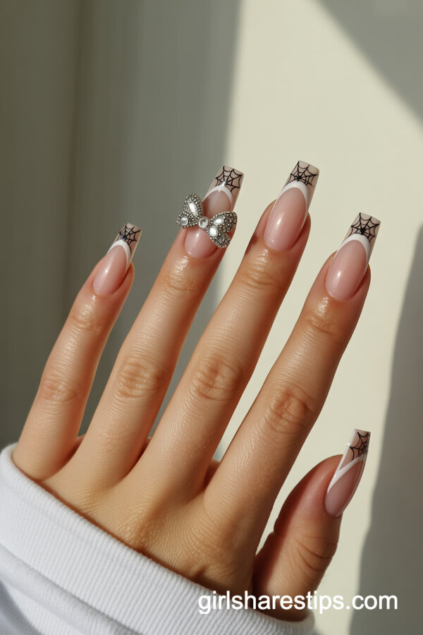 Almond nails with French tip spiderwebs and bows