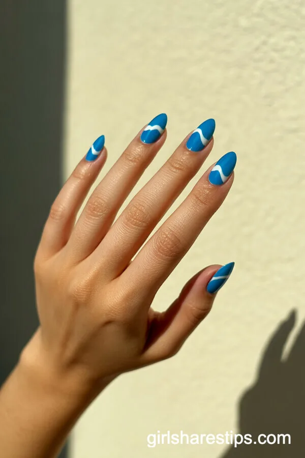 Riviera Blue Almond Nails with Minimalist White Wave Accents