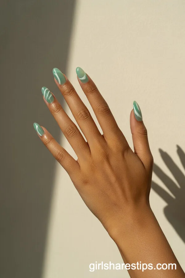 Translucent Sea Glass Green Almond Nails with Abstract White Art