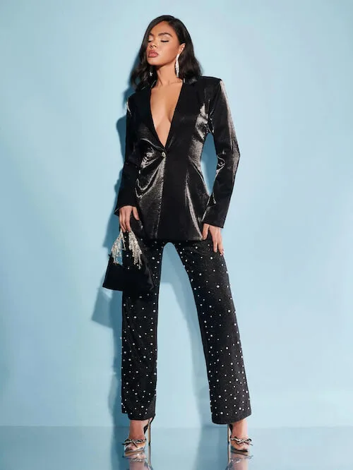 a beautiful black woman wearaing a chic black blazer, and a pair of black sequin pants