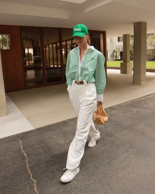 green baseball hat and green striped button down shirt