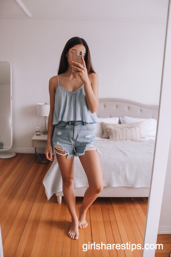 Light blue ruffled camisole top with distressed denim shorts