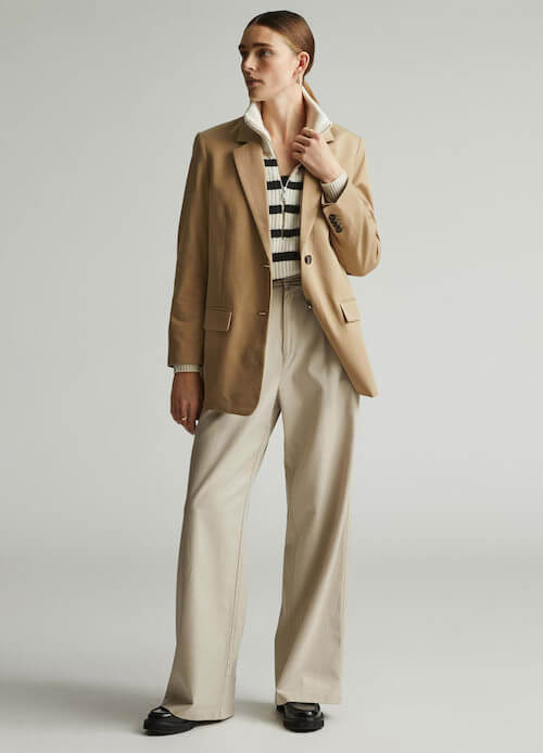 beige blazer, striped sweater and beige pants