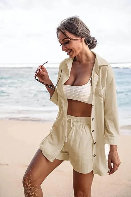 a woman wearing a beige shorts set at the beach