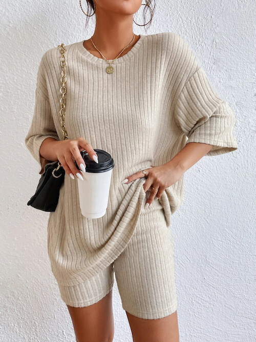 a woman wearing a beige biker shorts and beige oversized Tee set