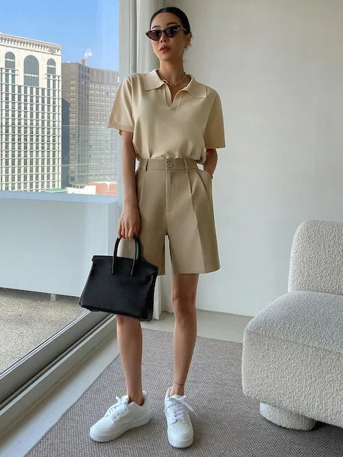 a Korean woman wearing a polo shirt and beige shorts