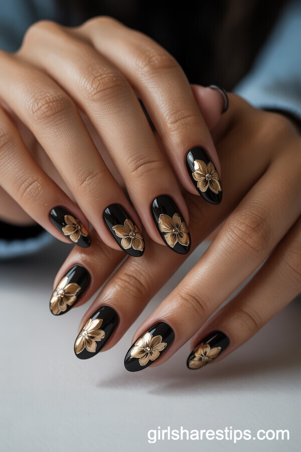 Glossy Black Almond Nails with Ornate Gold Floral Patterns