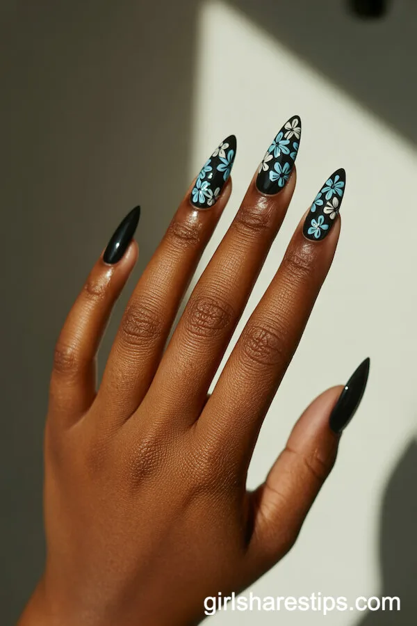Stiletto Nails with Black Base and Blue-White Floral Accent