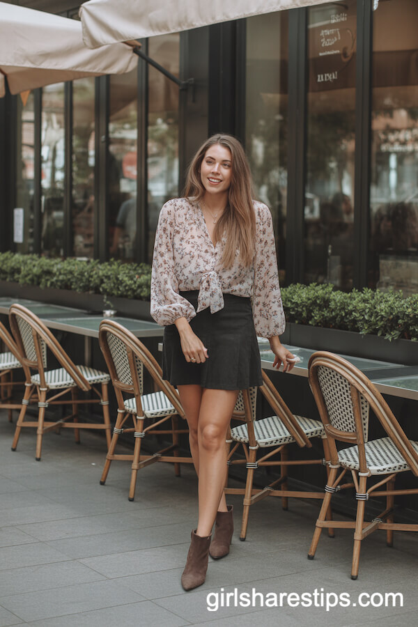 Feminine Touch: Black Mini Skirt with Flowy Floral Blouse and Ankle Boots