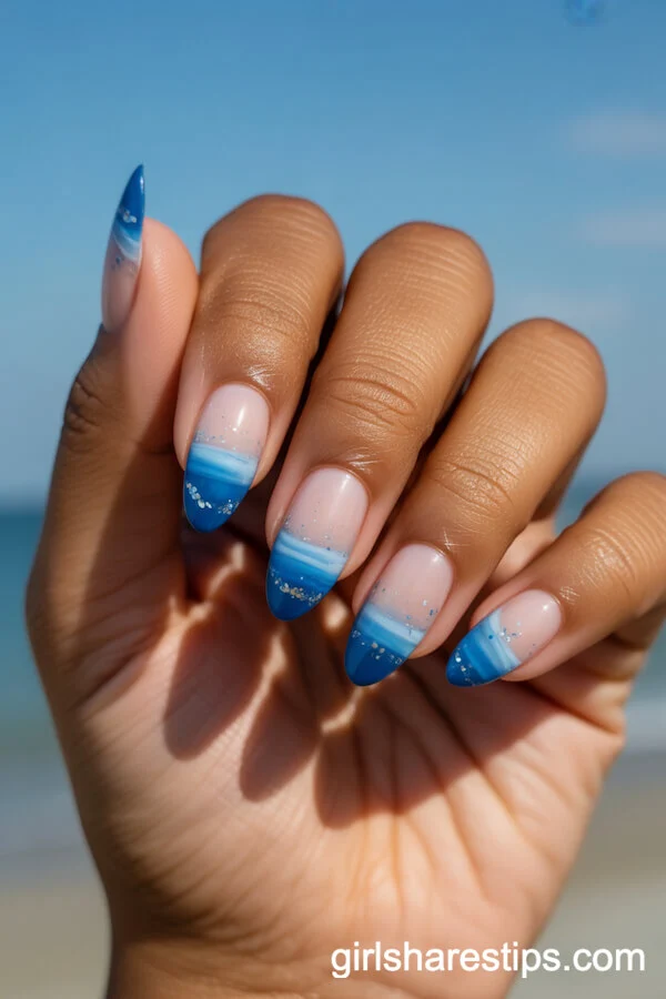 Blue Ombre Beach-Inspired Almond Nails with Glitter Accents