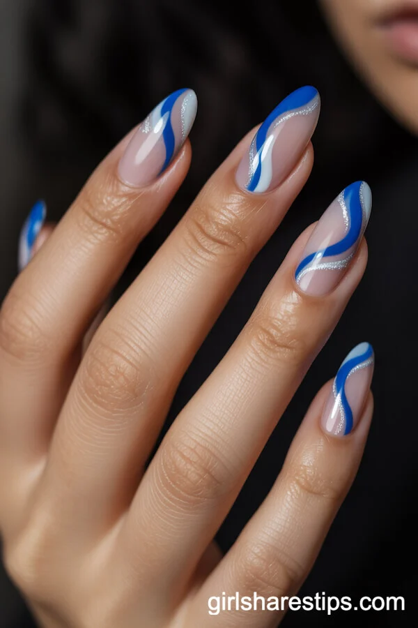 Almond Nails with Sapphire Blue and Silver Flowing Wave Designs