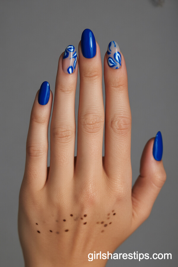 Cobalt Blue Oval Nails with Blue and White Abstract Floral Patterns