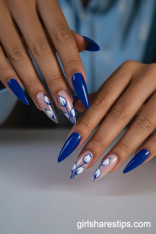Royal Blue Stiletto Nails Featuring Petite White Tulip Designs