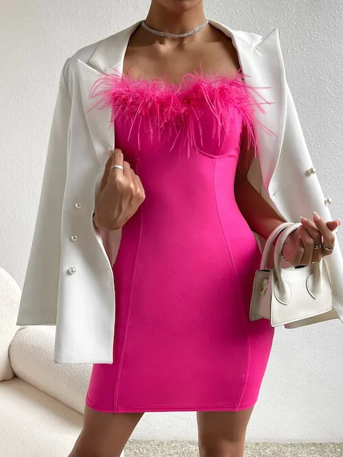 a woman wearing a sexy hot pink mini dress and an oversized white blazer