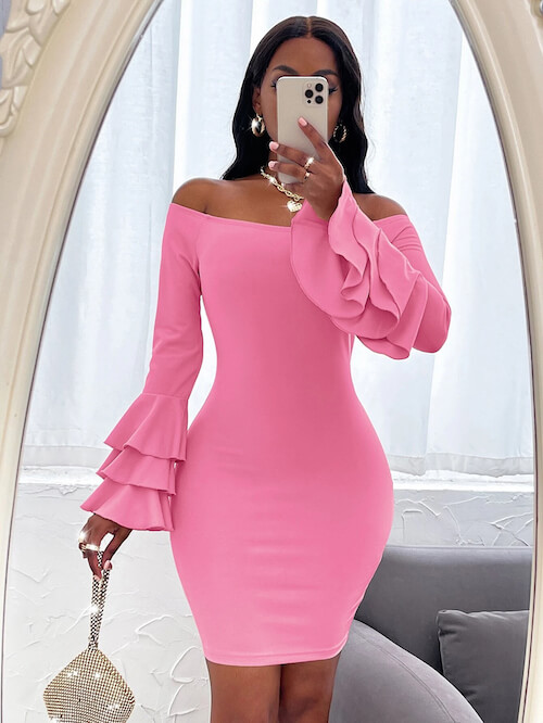 a woman wearing a pink off the shoulder bodycon mini dress and holding a shiny purse