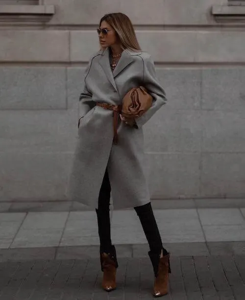 a beautiful black woman wearing chic neutral outfits