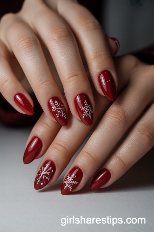 Deep Red Almond Nails with Delicate Snowflake Art