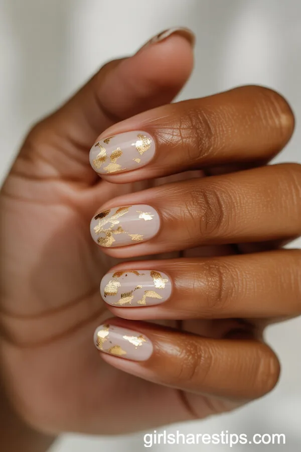 Short Oval Nude Nails with Chic Gold Confetti