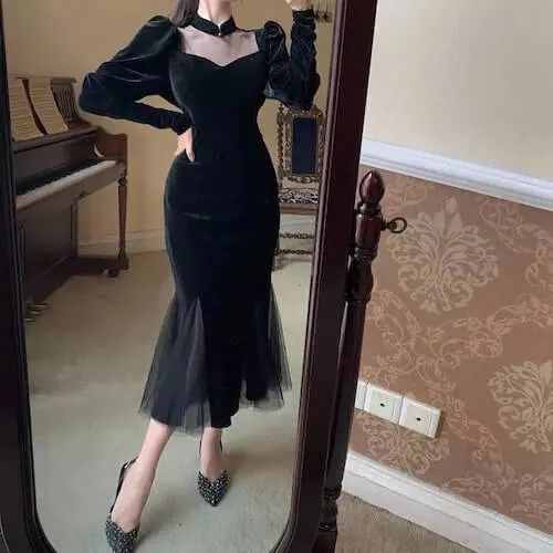 a woman wearing a long beautiful dress and black heels