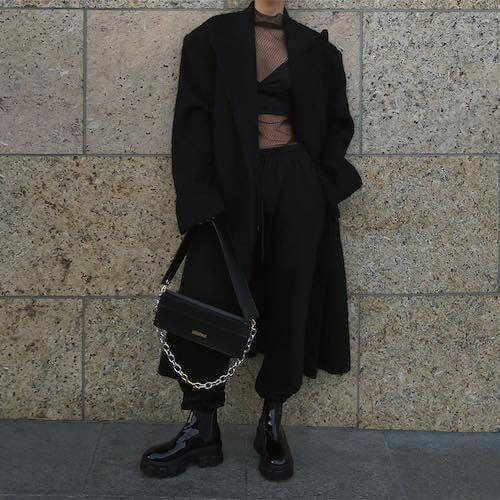 black coat, mesh top, and black pants