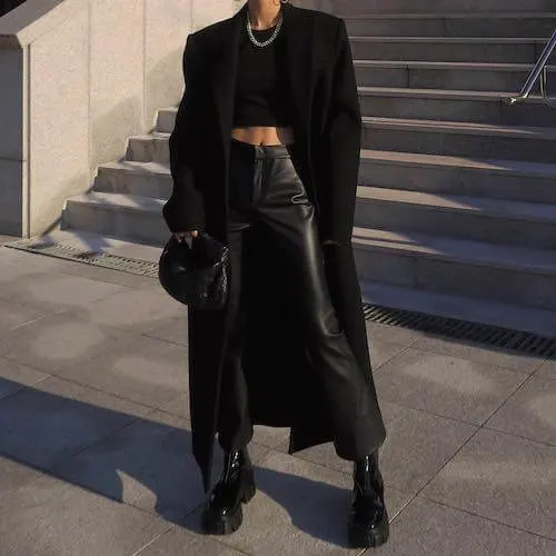 black crop top, black leather pants, and black coat