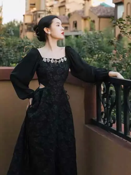 a woman wearing a Victoria style black dress