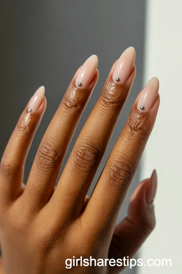 Almond Beige Nails with Metallic Stud Accents