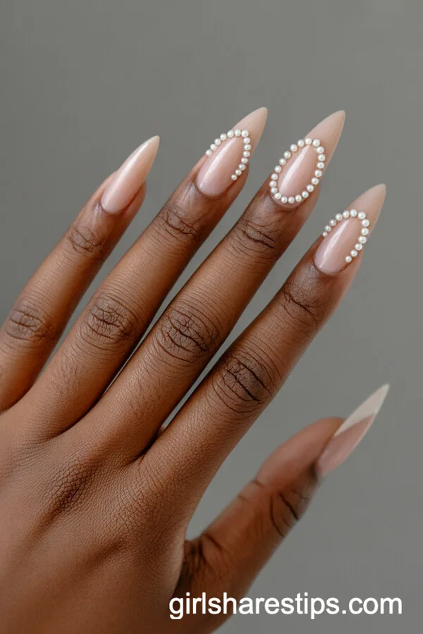 Stiletto Nude Nails with Tiny Pearl Embellishments