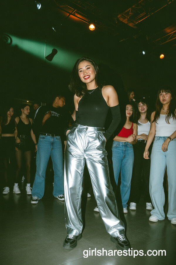 Shiny metallic pants and black bodysuit with chunky black sneakers