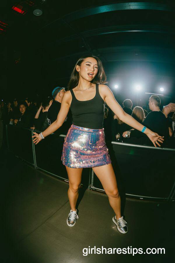 Sparkling sequin mini skirt and black tank top with metallic sneakers