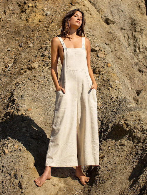 a woman wearing neutral color overalls