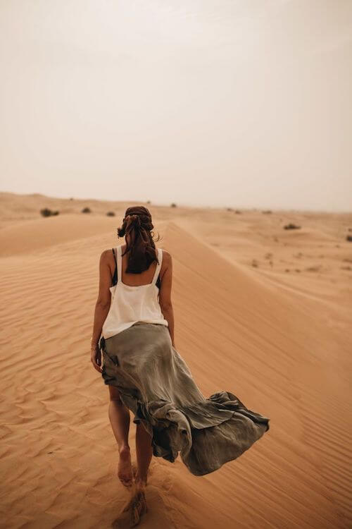 a beautiful wearing white tank top and flowy skirt