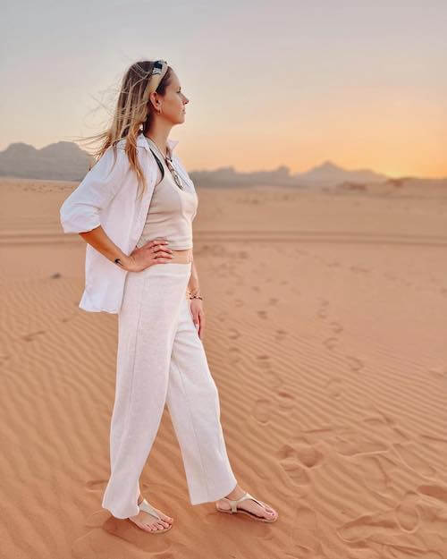a woman wearing white button up and white pants