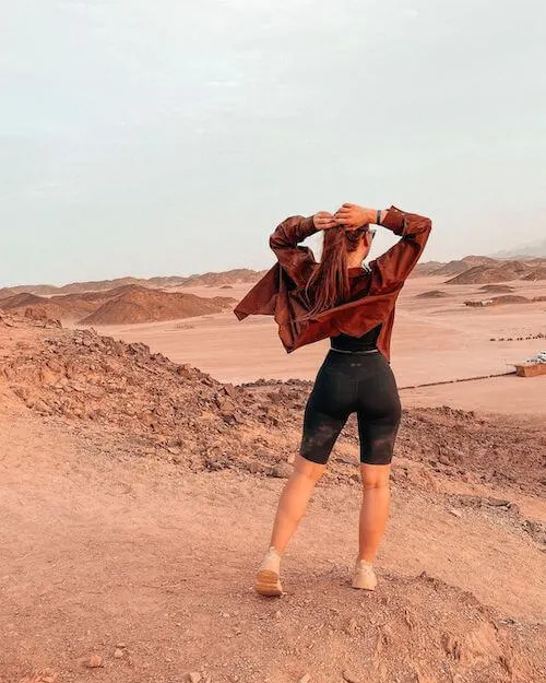 woman wearing brown light jacket and black biker shorts