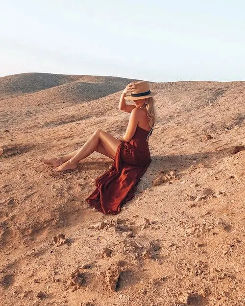 a sexy and chic out idea with red dress and a straw bag