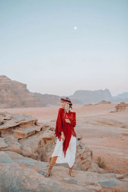 woman wearing red knit scarf and flowy white dress