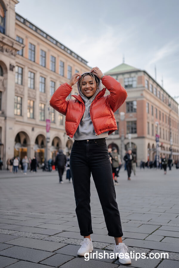 Orange Cropped Puffer with Black Jeans and Sneakers