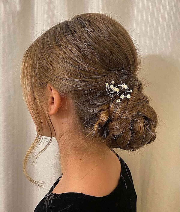 Low Twisted Bun With Floral Accent