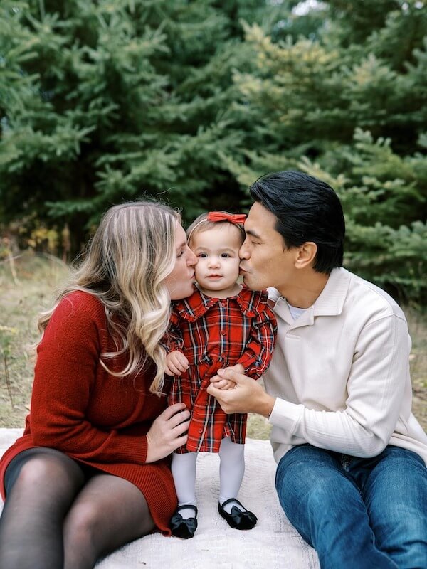 Parents Kissing Baby in Plaid