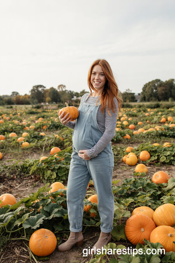 Denim Maternity Jumpsuit Over Striped Tee and Low-Heeled Boots