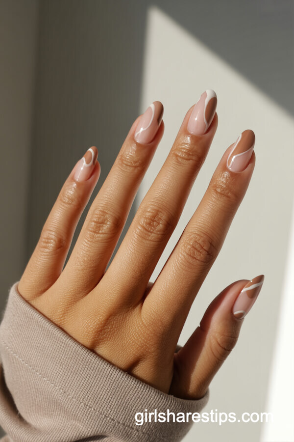 Almond nude nails with abstract line art