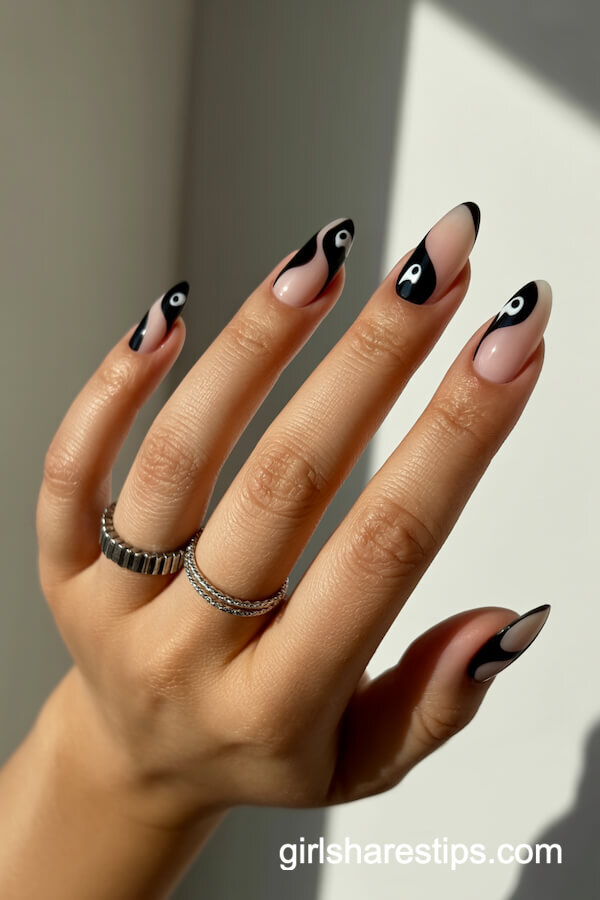 Nude and black yin-yang nails with ghost eyes
