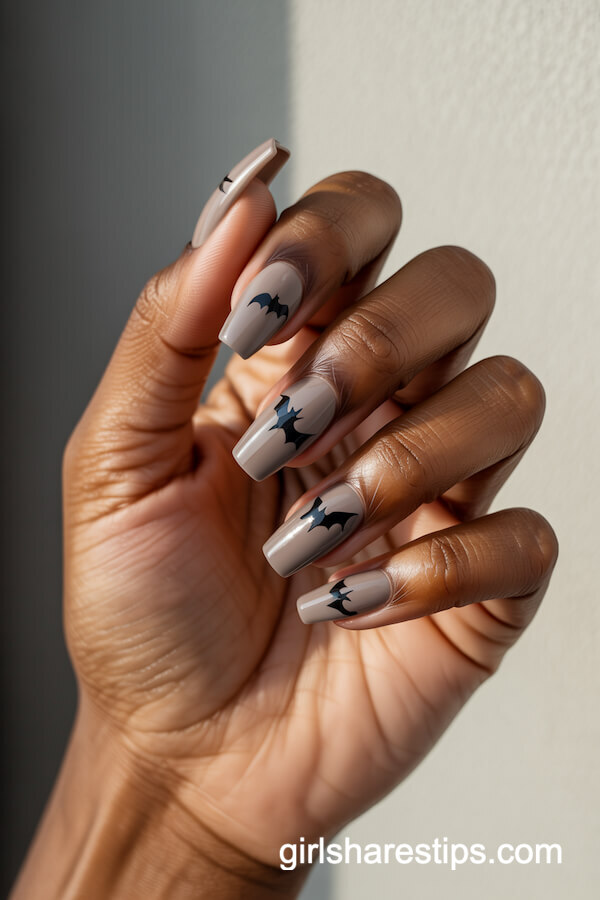 Matte taupe nails with glossy black bat silhouettes