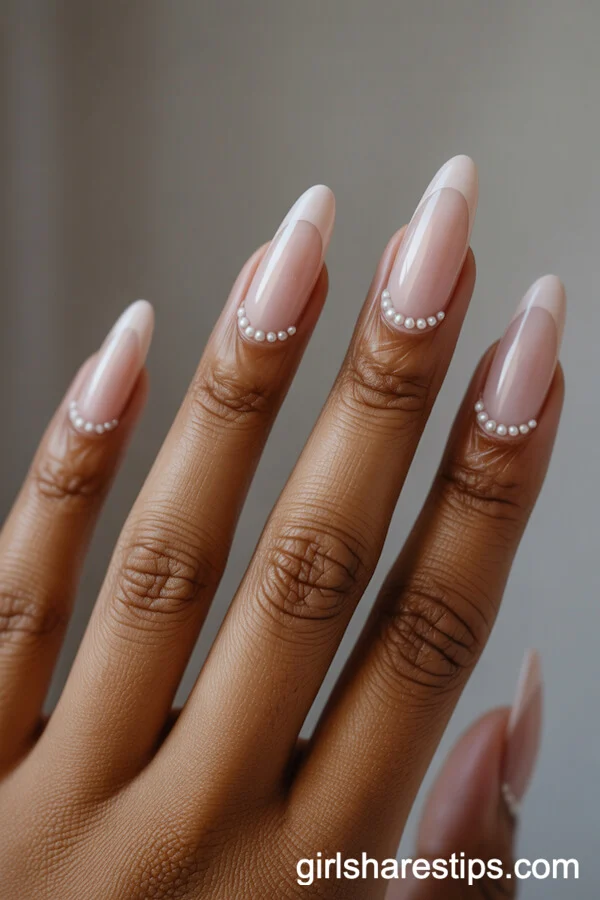 Classic Nude Almond Nails with Pearl Embellishments