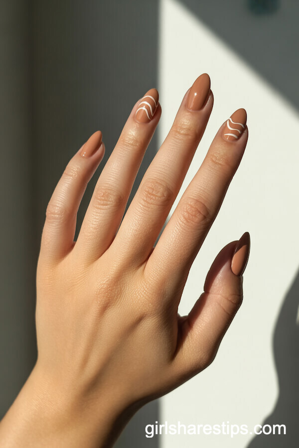 Wheat-Neutral Almond Nails with Delicate White Wavy Art