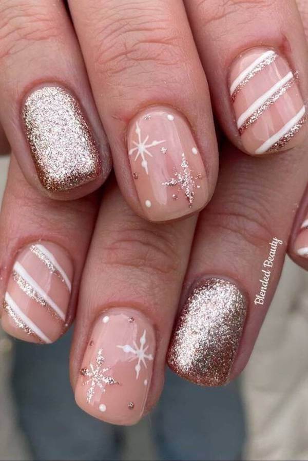 Glittery Nude Nails With Snowflakes And Stripes