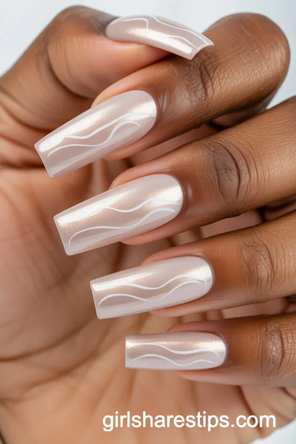 Glossy Nude Chrome Coffin Nails with Wavy Champagne Lines
