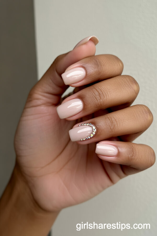 Glossy Nude Coffin Nails with Subtle Rhinestones