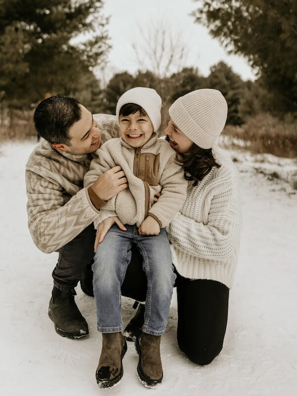 Playful Family Cuddle in the Snow